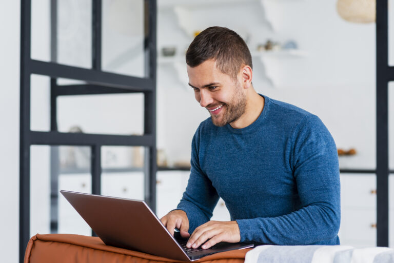smiley-man-working-laptop-from-home
